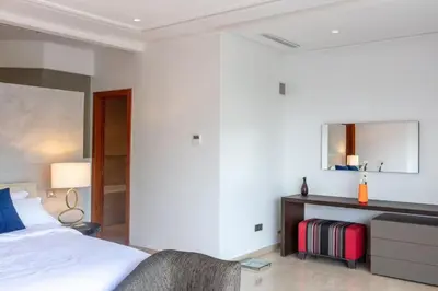 a hotel room with a bed and a mirror at Villa Lamaan - Domaine prive piscine et hammam in Douar bel Rhanodour