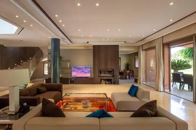 a large living room with couches and a tv at Villa Lamaan - Domaine prive piscine et hammam in Douar bel Rhanodour