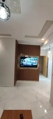 a large room with a flat screen tv on a wall at Superbe appartement à Meknes in Meknès