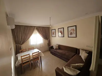 a living room with a couch and a table at Appartement équipé! in Ouarzazate