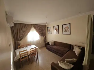 a living room with a couch and a table at Appartement équipé! in Ouarzazate