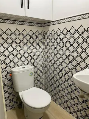 a bathroom with a white toilet and a sink at Appartement équipé! in Ouarzazate