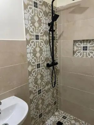 a bathroom with a shower and a sink at Appartement équipé! in Ouarzazate