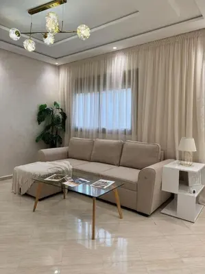 a living room with a couch and a table at Appartement Moderne in Meknès