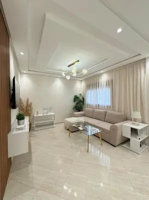 a living room with a couch and a table at Appartement Moderne in Meknès