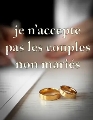 two gold wedding rings sitting on top of a book at Appartement Moderne in Meknès