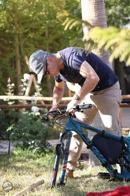 a man is standing next to a bike at Superides Camp in Ourika