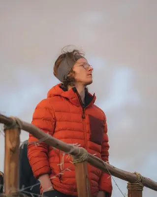 a woman in a red jacket standing on a boat at Superides Camp in Ourika