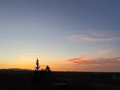 a sunset with a tree in the foreground at Superides Camp in Ourika
