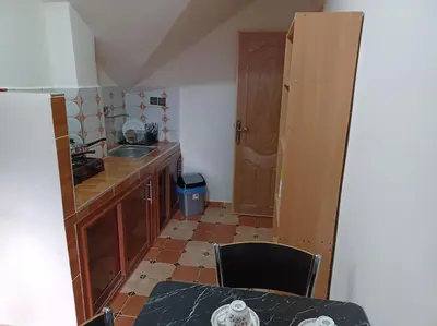 a small kitchen with a table and a sink at Lovely & Cozy Self-Contained Studio Apartment For 2 Guests Apt No 3 in Ifrane