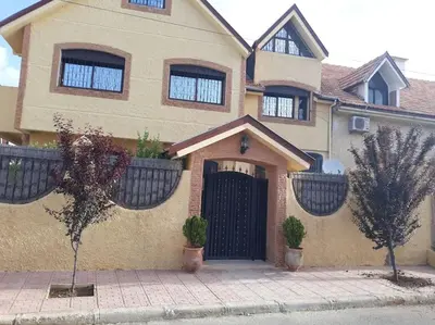 a house with a black door with potted plants on it at Lovely & Cozy Self-Contained Studio Apartment For 2 Guests Apt No 3 in Ifrane