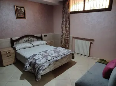 a bedroom with two beds and a window at The Orchard Cozy & Comfy Apartment 1 in Ifrane