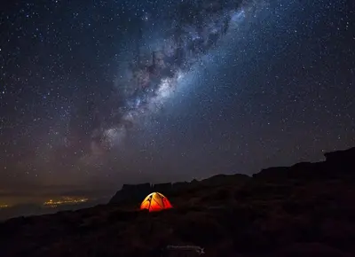a tent sitting on a hill under a starry sky at Time to Discover Wild Camp in Merzouga