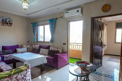a living room with a purple couch and a table at Bab Alas apartments N2 in Ourika valley in Ourika