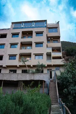 a tall building with stairs in front of it at Bab Alas apartments N2 in Ourika valley in Ourika