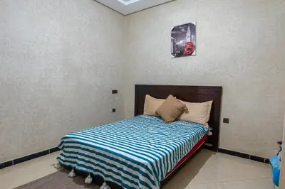 a bedroom with a bed with a car on the wall at Bab Alas apartments N2 in Ourika valley in Ourika