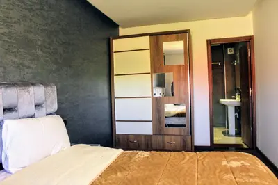a bedroom with a bed and a closet and a mirror at شقق الاسد افران in Ifrane