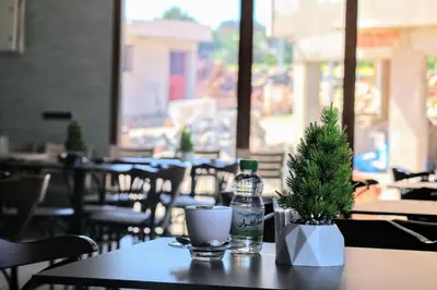a table with a bottle of water and a christmas tree on it at شقق الاسد افران in Ifrane