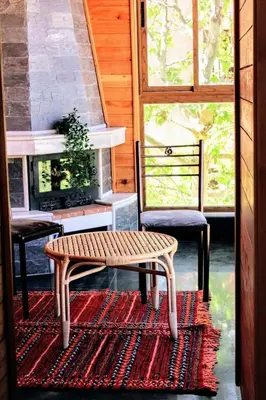 a bench and two chairs on a rug in a room at شقق الاسد افران in Ifrane