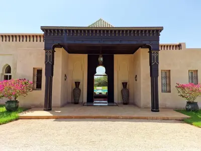 an entry to a building with a large doorway at Villa Alcázar Marrakech in Had Abdallah Rhiat