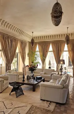 a large living room with couches and a table at Villa Alcázar Marrakech in Had Abdallah Rhiat