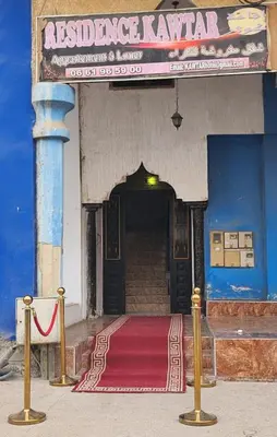 an entrance to a building with a red carpet in front at residence kawtar in Meknès