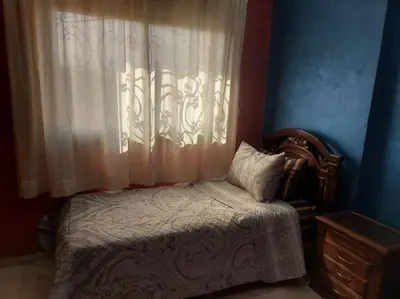 a bedroom with a bed with a window and a dresser at séjour confort et design à Fès in Fès