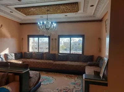 a living room with a couch and a chandelier at séjour confort et design à Fès in Fès