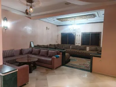 a large living room with couches and a table at séjour confort et design à Fès in Fès