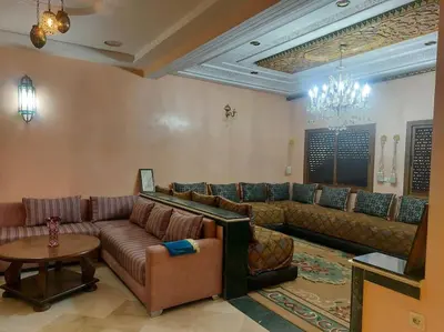 a large living room with couches and a chandelier at séjour confort et design à Fès in Fès