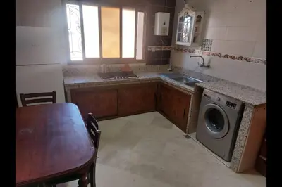 a kitchen with a sink and a washing machine at séjour confort et design à Fès in Fès