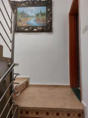 a stairway in a room with a painting on the wall at séjour confort et design à Fès in Fès