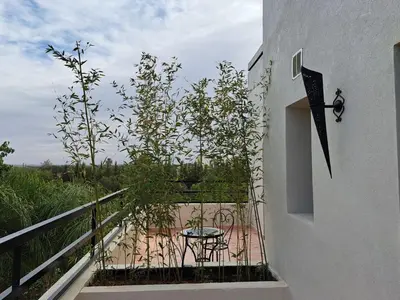 a balcony with a table and chairs on it at Villa Rahma in Marrakech