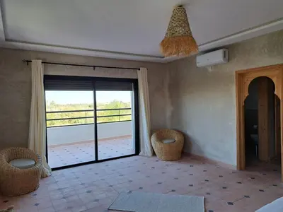 a room with a sliding glass door with a balcony at Villa Rahma in Marrakech