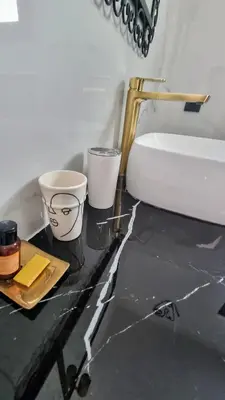 a bathroom with a white toilet and a counter with a sink at Stylish hôtel in Marrakech