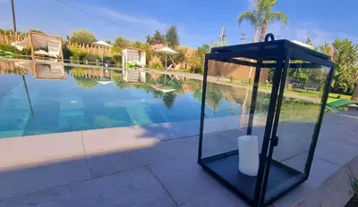 a large pool of water with a black object next to it at Stylish hôtel in Marrakech