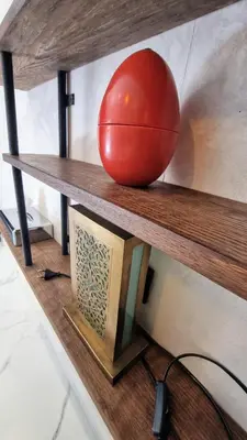 a red ball sitting on a wooden shelf at Stylish hôtel in Marrakech