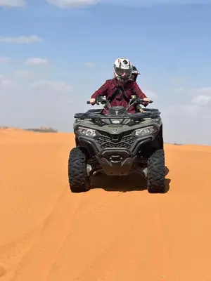 a person riding a four wheeler in the desert at Sahara mirage camp in Merzouga