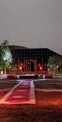 a large building is lit up at night at Sahara mirage camp in Merzouga