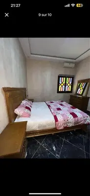 a bed in a room with two stained glass windows at Soulta villa in Marrakech