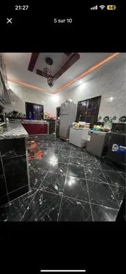 a room with a black tile floor and a room with counters at Soulta villa in Marrakech
