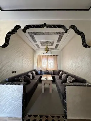a living room with a couch and a table at Merzouga Dunes Apartment in Merzouga