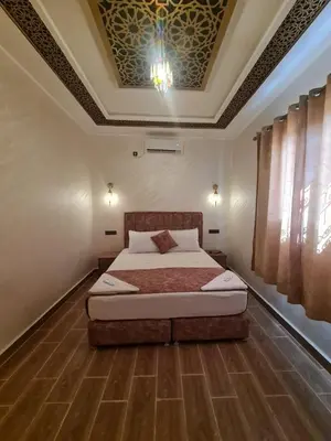 a bedroom with a bed and a coffered ceiling at Merzouga Dunes Apartment in Merzouga