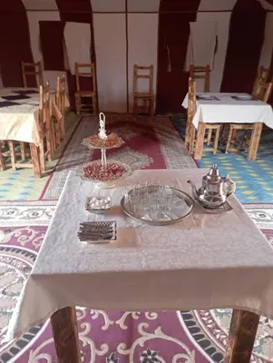 a table with a plate of food on top of it at Mars Desert Camp Merzouga in Merzouga