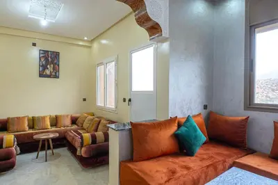 a living room with a couch and some windows at Bab Atas appartment N4 in Ourika Valley in Marrakech