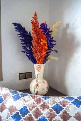 a vase with flowers in it sitting on a table at Bab Atlas appartment N3 in Ourika valley in Aghbalou