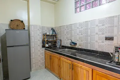 a kitchen with a white refrigerator and a sink at Bab Atlas appartment N3 in Ourika valley in Aghbalou