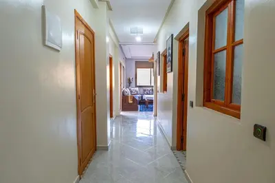 a hallway of a house with doors and tiled floors at Bab Atlas appartment N3 in Ourika valley in Aghbalou
