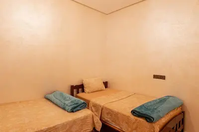 a room with two twin beds in it at Bab Atlas appartment N5 in Ourika valley in Aghbalou