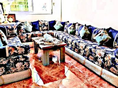 a living room with a couch and a table at Luxury 3-bedroom apartments 5-min to the Airport in Fès
